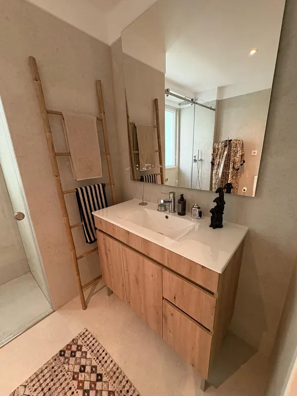 Bathroom with an oak vanity, a ladder towel rail and a patterned rug